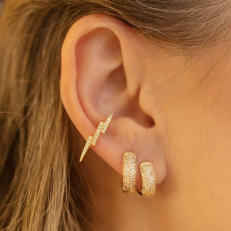 13.0234.1.O - Piercing de desenho raio longo cravejado