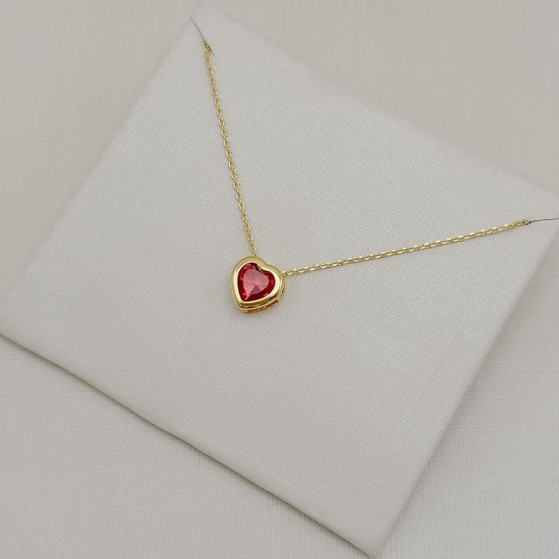 09.2554.6.O - (45) Colar de elos cartier com pingente de coração em cravação inglesa com galeria