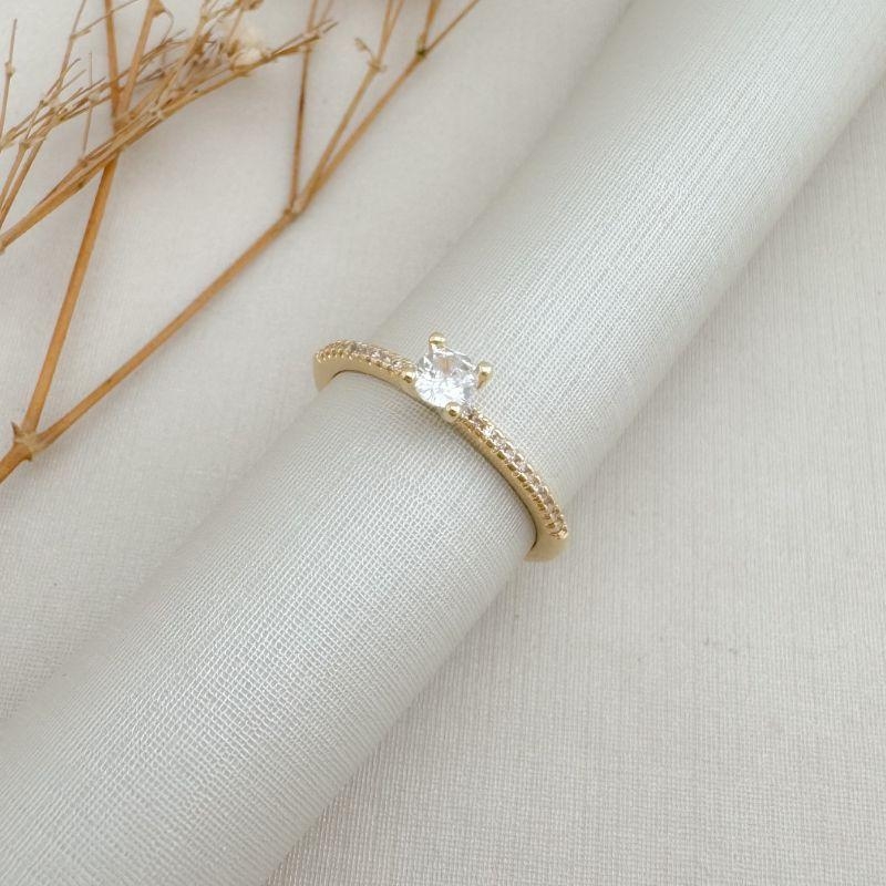 03.2445.1.O - (17) Anel solitário princesa com aro cravejado