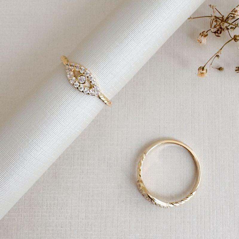 01.0207.1.O - (12) Anel falange de desenho olho cravejado com aro liso