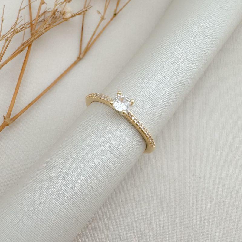 03.2445.1.O - (14) Anel solitário princesa com aro cravejado