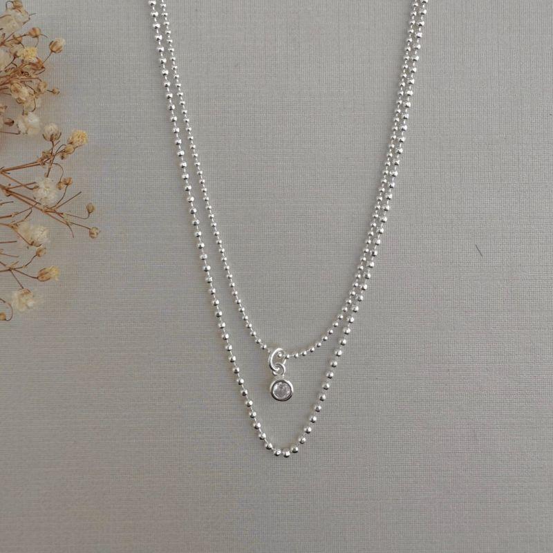 09.2248.1.S - (35 - 40) Colar duplo de malha em bolinhas lisas, menor com pingente ponto de luz