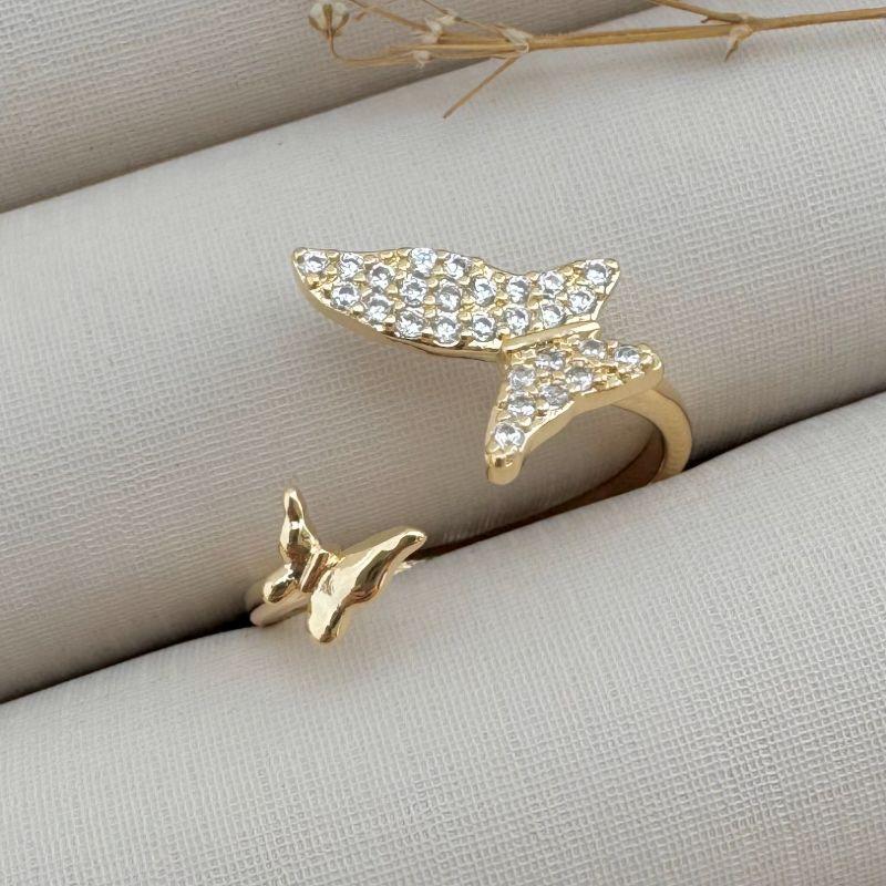 03.2318.1.O - (17 ao 21) Anel aberto de aro liso com uma borboleta em cada ponta, menor lisa e maior cravejada