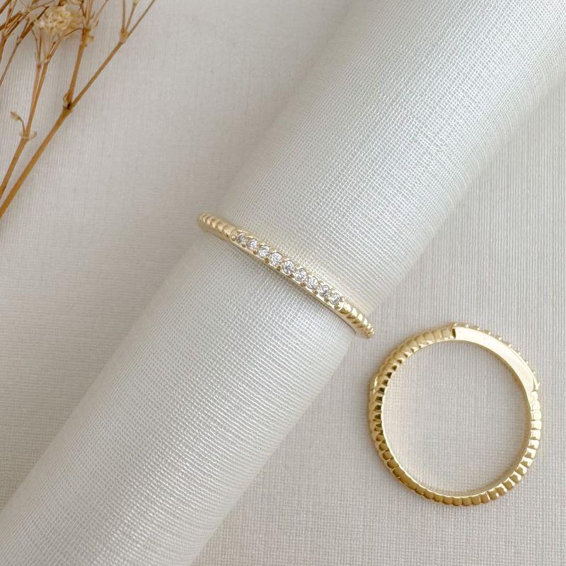 03.2498.1.O - (14) Anel de aro em efeito espiral com uma linha cravejada de nove zircônias