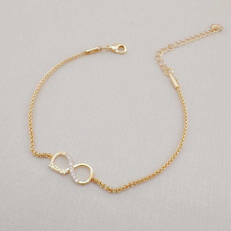12.2115.1.O - Pulseira de malha agrafe oca com infinito central com escrita AMOR
