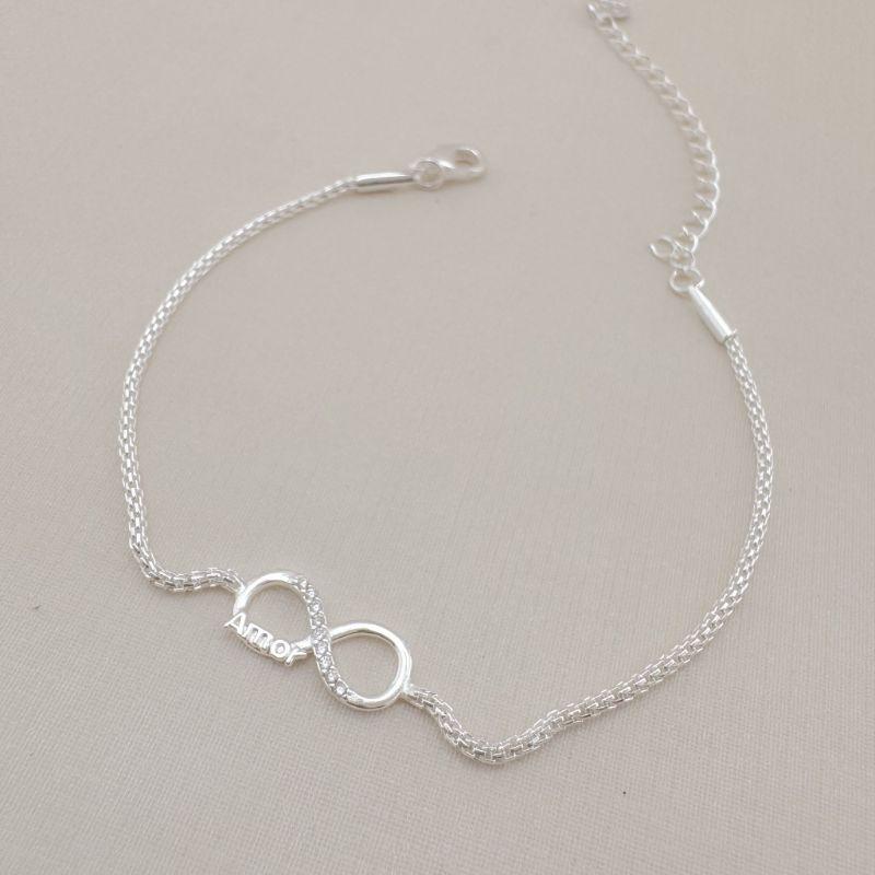 12.2115.1.S - Pulseira de malha agrafe oca com infinito central com escrita AMOR