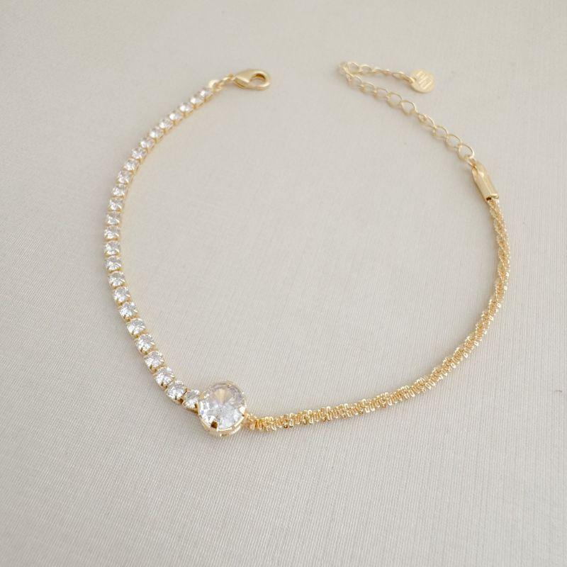 12.2214.1.O - Pulseira com central em ponto de luz com um lado em riviera e outro em malha veludo