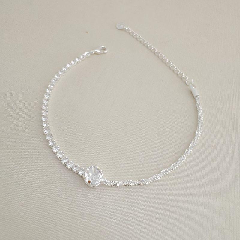 12.2214.1.S - Pulseira com central em ponto de luz com um lado em riviera e outro em malha veludo