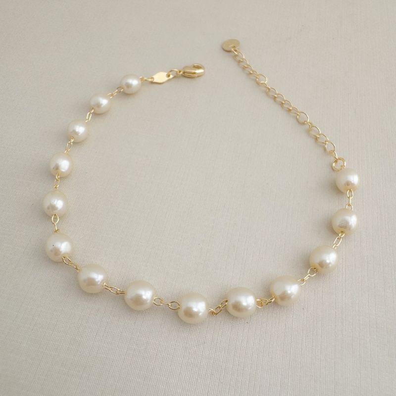 12.2221.15.O - Pulseira de perolados ovais em elos circulares clássicos