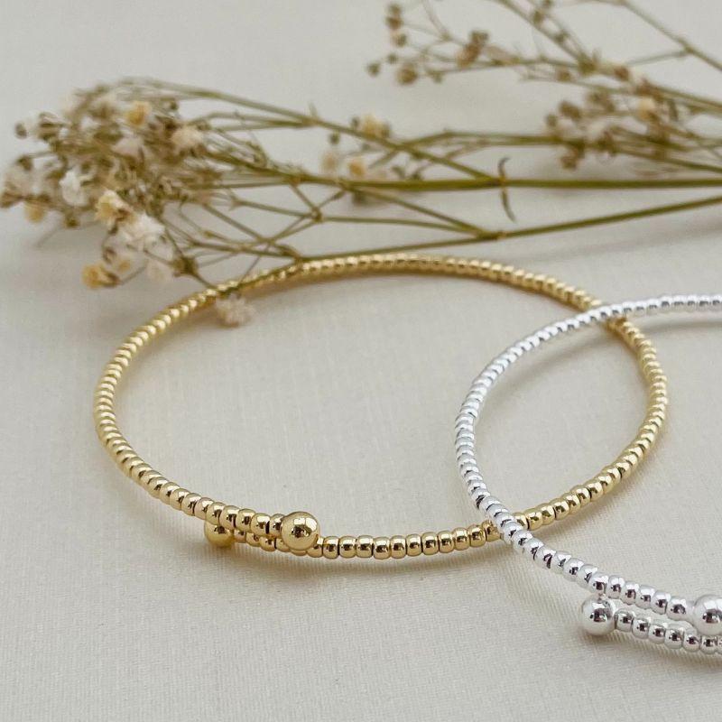 04.0197.0.O - Bracelete mola aberto de efeito entremeio liso com bolinha nas pontas