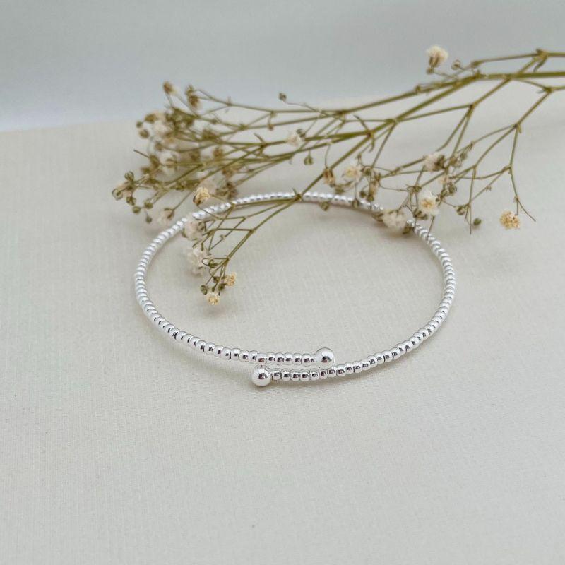 04.0197.0.S - Bracelete mola aberto de efeito entremeio liso com bolinha nas pontas