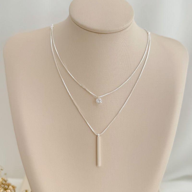 09.2374.1.S - (40) Colar duplo com ponto de luz e palito