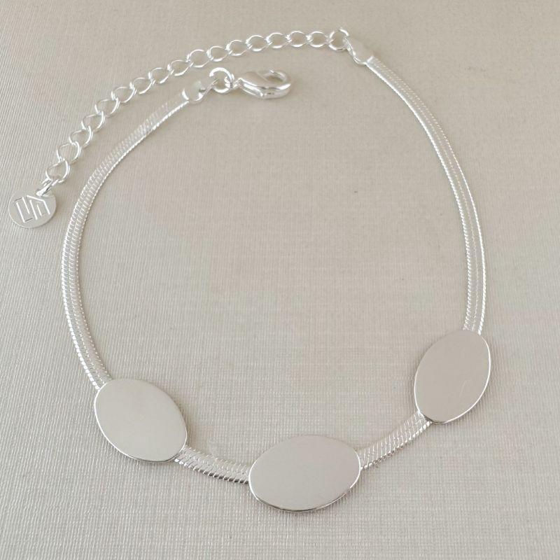 12.2232.0.S - Pulseira de malha fita com três chapas ovais lisas