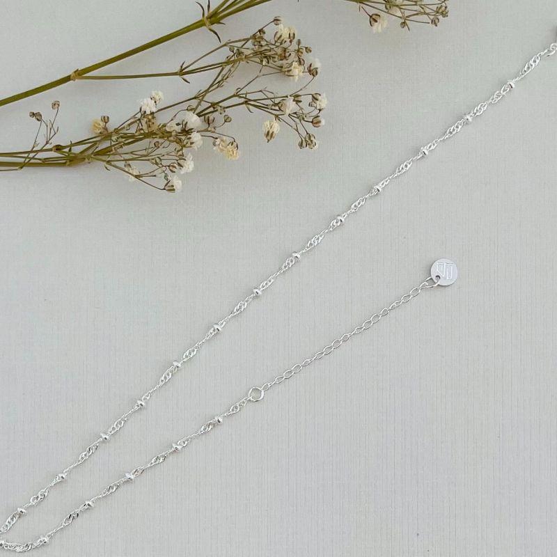 14.0306.0.S - Tornozeleira de malha dupla em espiral com bolinhas lisas