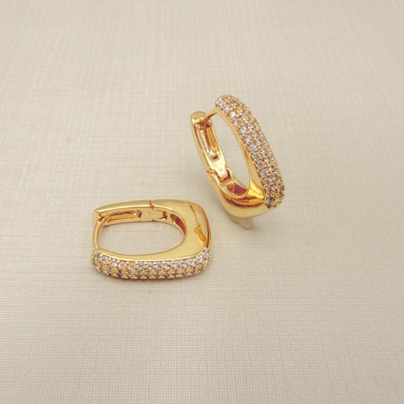 05.3107.1.O - Argola em formato retangular abaloado com três colunas de zircônias na frente.