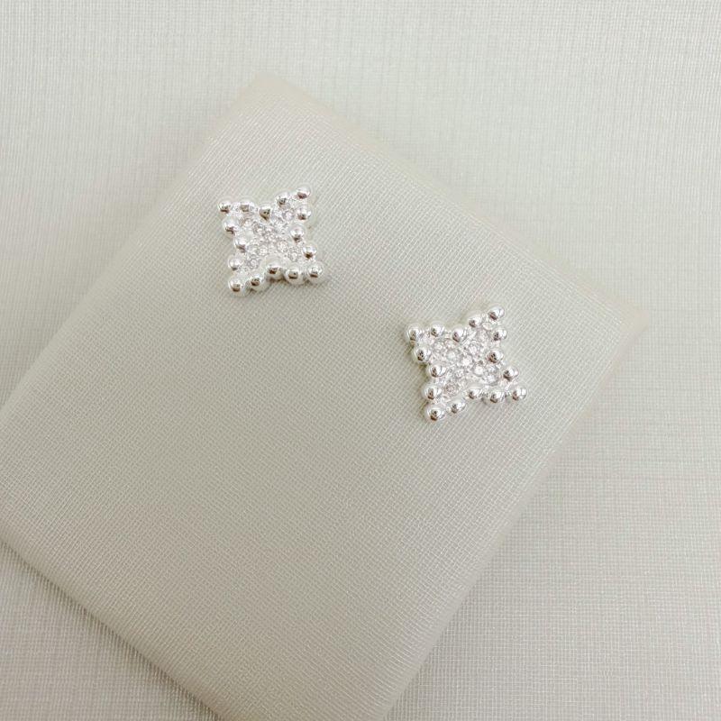 07.2782.1.S - Brinco estrela de quatro pontas com bordas pontilhadas.