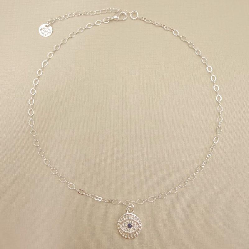 14.0318.4.S - Tornozeleira de elos ovais com pingente moeda com olho grego cravejado