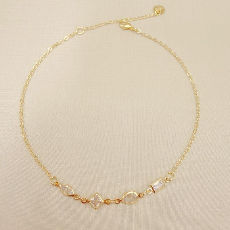 14.0323.0.O - Tornozeleira de elos simples com quatro pontos de luz em formato variado