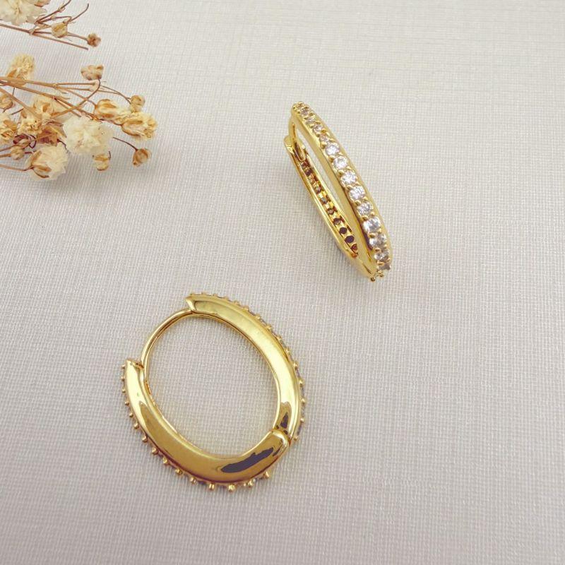 05.3109.1.O - Argola oval com uma coluna de cravação frente e atrás crescente