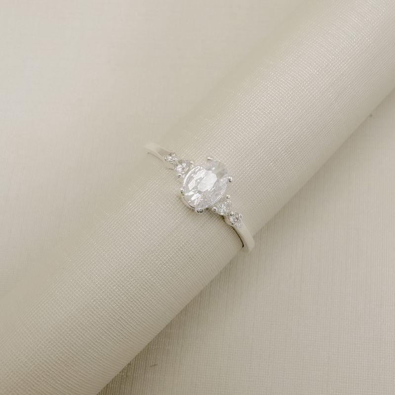 03.2591.1.S - (18,5) Anel solitário em pedra oval duas mini zircônias nas laterais em aro liso