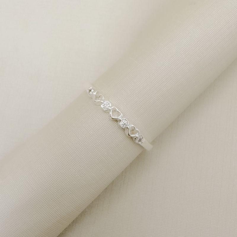 03.2597.1.S - (21) Anel de aro liso com três silhuetas de coração e pontos de luz intercalados