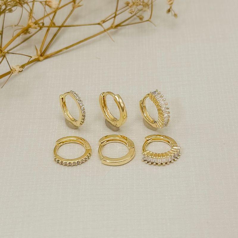 05.3172.1.O - Trio de argolas diferentes, baguete com garras; lisa e uma coluna de cravação