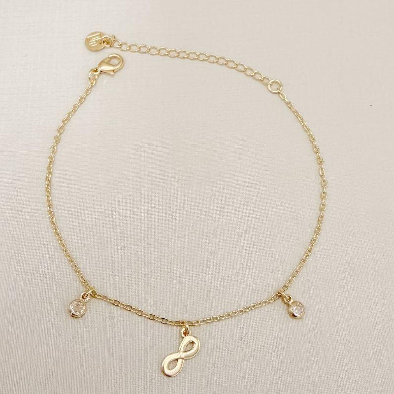 12.2290.1.O - Pulseira de elos cartier com pingente de infinito e dois ponto de luz